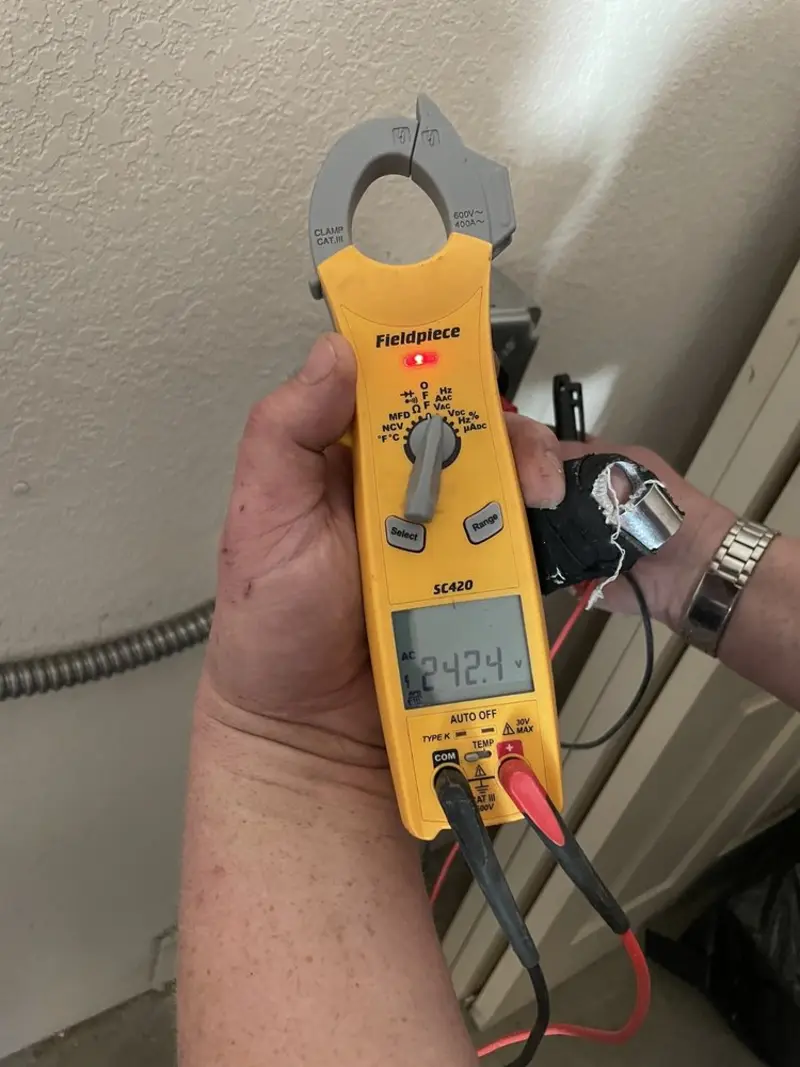 Voltage testing with clamp meter during Outlet Installation in Thompson